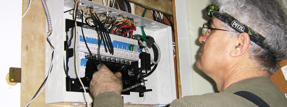 Licensed & Insured Master Electrician Working On Power Box
